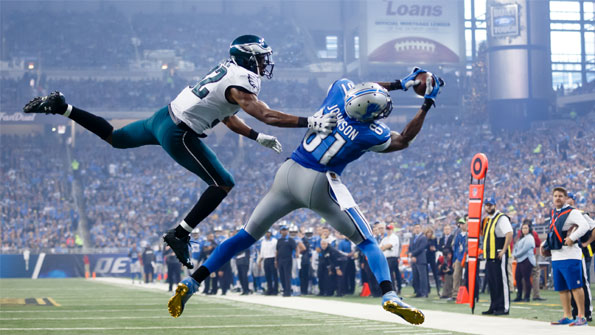 Image of Calvin Johnson catching an american football during a game against the Seahawks. Earnie creative design